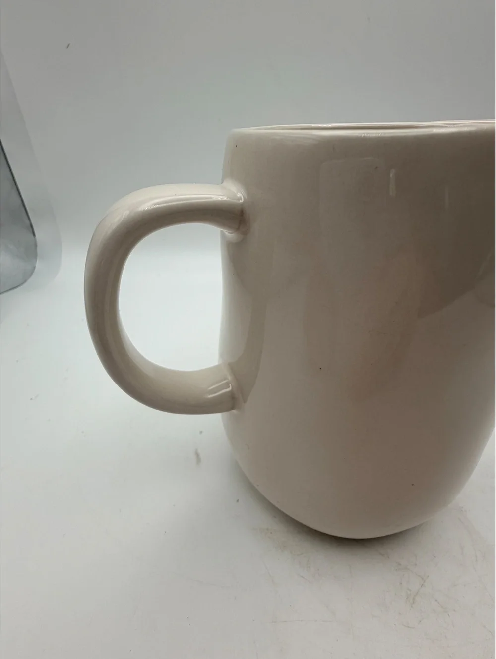 Rae Dunn white ceramic syrup pitcher.with handle. In like new condition